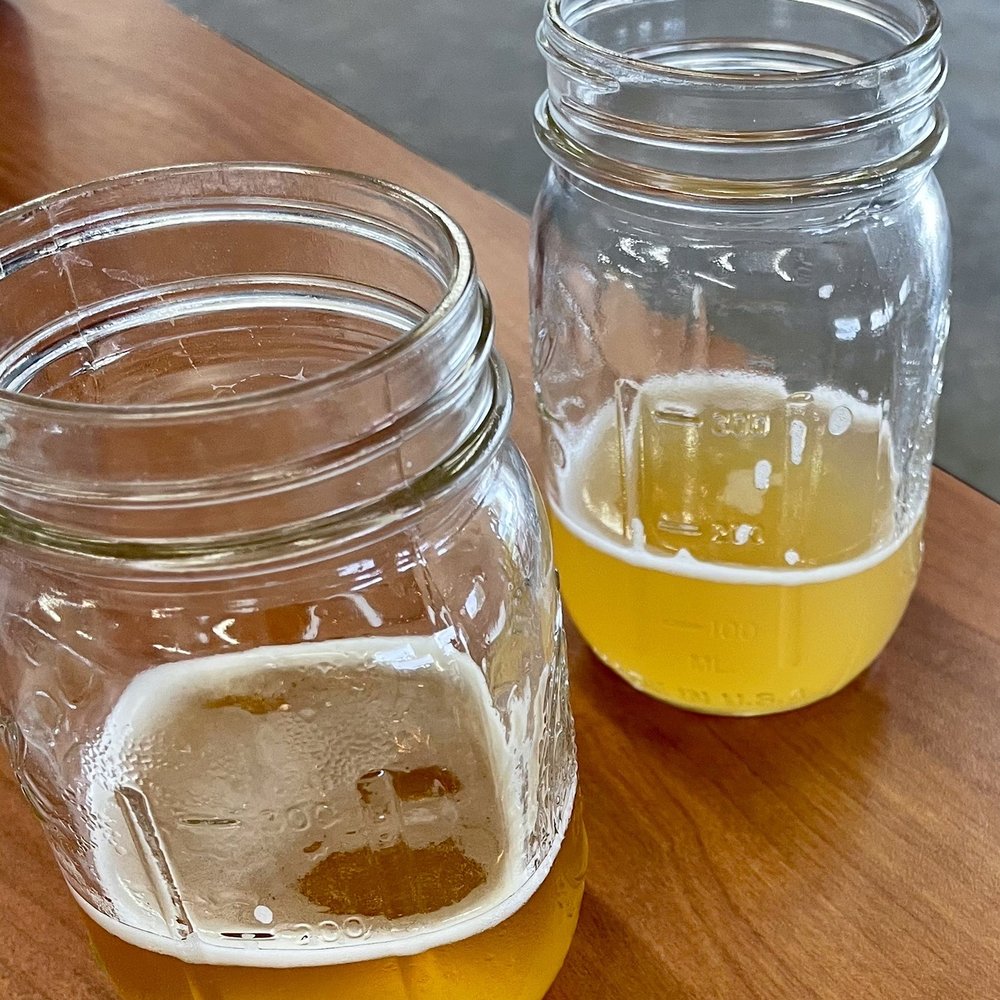 two glasses of beer on a table