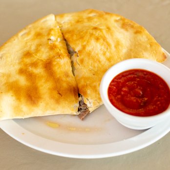 Vince's Pizzaria - two quesadillas on a plate with a small bowl of ketchup - Pizza Near Me - Beloit, Wisconsin