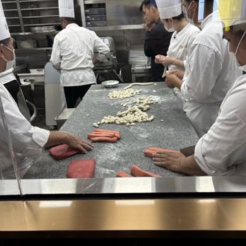 Paradise Dynasty - Booth with view of the kitchen staff prepping food - Singaporean Near Me - Costa Mesa, California Paradise Dynasty - Booth with view of the kitchen staff prepping food - Singaporean Near Me - Costa Mesa, California
