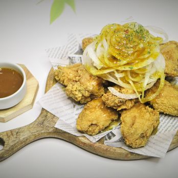 Koko Chicken 92 - a plate of fried chicken with a side of sauce - Korean Near Me - Sunrise, Florida Koko Chicken 92 - a plate of fried chicken with a side of sauce - Korean Near Me - Sunrise, Florida