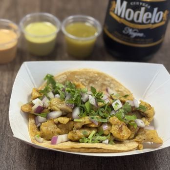 El Serranito Taqueria - Pollo taco on a double corn tortilla, with onions and cilantro, salsas, and a cold Modelo - Mexican Near Me - Marietta, Georgia El Serranito Taqueria - Pollo taco on a double corn tortilla, with onions and cilantro, salsas, and a cold Modelo - Mexican Near Me - Marietta, Georgia