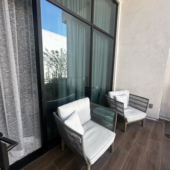 Thompson Palm Springs - Balcony and exterior door view - Hotels Near Me - Palm Springs, California Thompson Palm Springs - Balcony and exterior door view - Hotels Near Me - Palm Springs, California