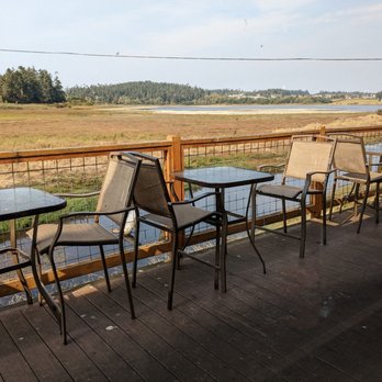 Callen's Restaurant - tables and chairs on a deck overlooking a marsh - New American Near Me - Coupeville, Washington Callen's Restaurant - tables and chairs on a deck overlooking a marsh - New American Near Me - Coupeville, Washington