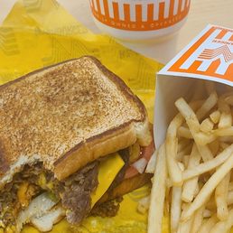 A large iced tea, a large French fry, and the Star of the Show a Whataburger Chili Cheese Burger.