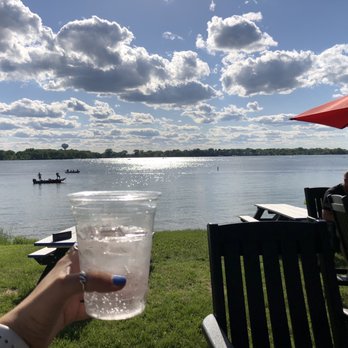 Sunset Pavilion - a person holding a glass of water - Beer Gardens Near Me - Lake Zurich, Illinois Sunset Pavilion - a person holding a glass of water - Beer Gardens Near Me - Lake Zurich, Illinois