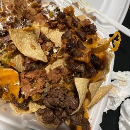 nachos in a styrofoam container nachos in a styrofoam container