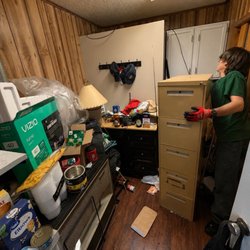Employee reaching for space for file cabinet