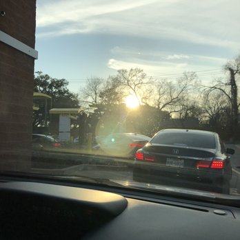 McDonald's - the sun setting behind a car - Burgers Near Me - Houston, Texas