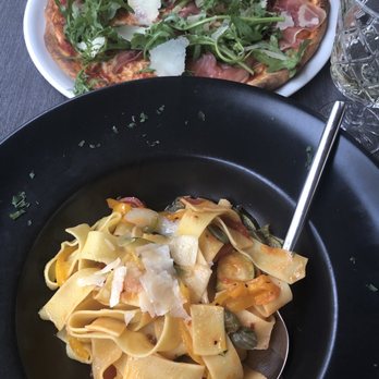 Sto bene - Parma pizza in back with vegetable papardelle in front - Italian Near Me - Salzburg, 5 Sto bene - Parma pizza in back with vegetable papardelle in front - Italian Near Me - Salzburg, 5
