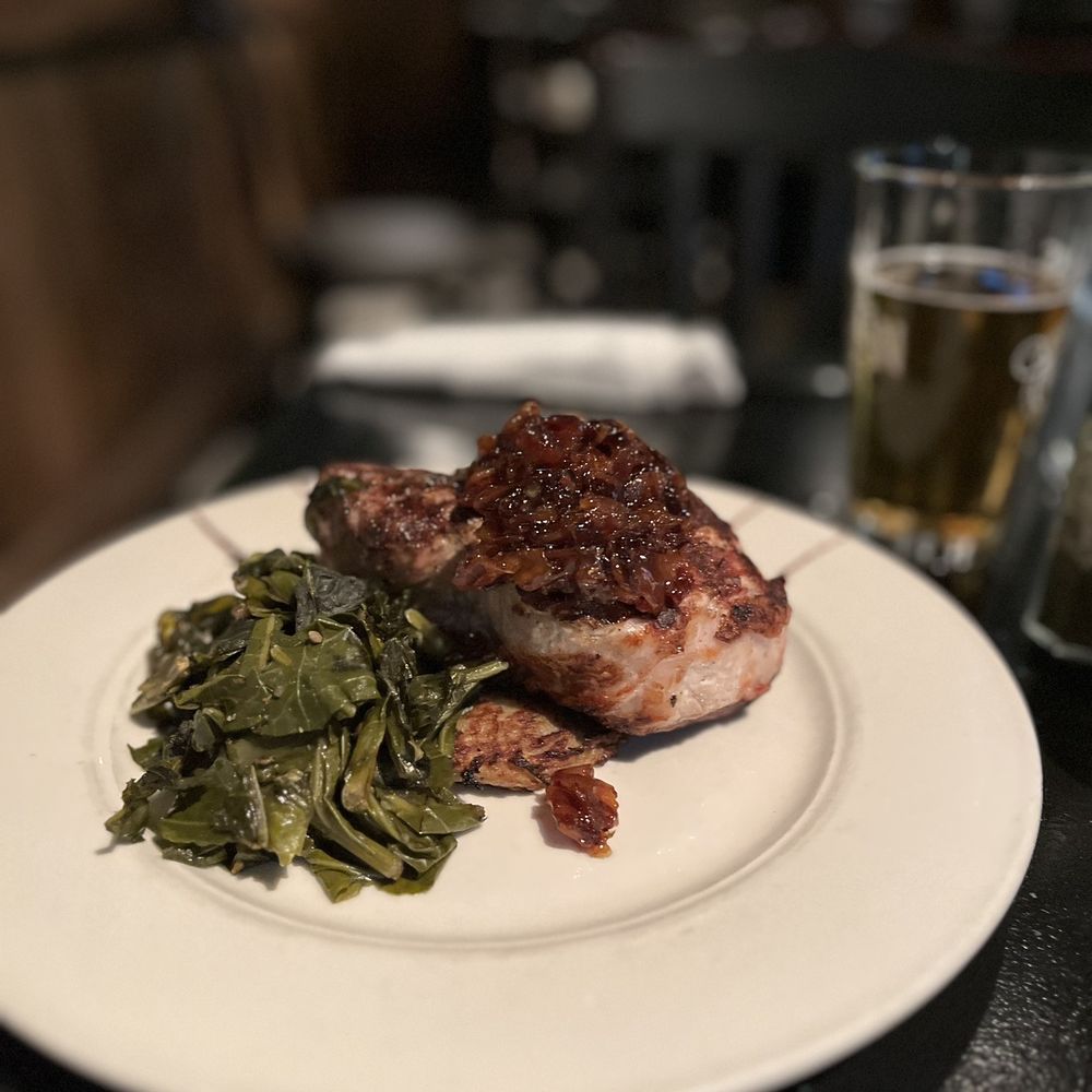 Diamondback Grill - Pork Chop with collards and a potato cake - American Near Me - Winston Salem, North Carolina