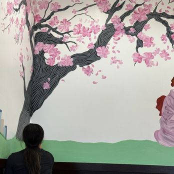 Sushi On Tatum - Young woman completing a mural on the wall - Sushi Bars Near Me - Phoenix, Arizona