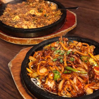 Five Senses - Upper dish is the "Dol Pan Kimchi Bokum Bap" and the lower dish is the "Nak Ji Bokum". Both are spicy dishes, especially the Nak Ji Bokum. - Korean Near Me - New York, New York