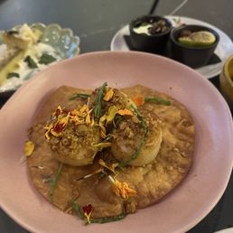 Hokkaido scallops, marinated olives and potato tempura in the back Hokkaido scallops, marinated olives and potato tempura in the back