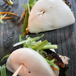 Malabito Street Cha Teahouse - Bao (Vietnamese-inspired bun) with juicy pork inside, garnished with vegetables.