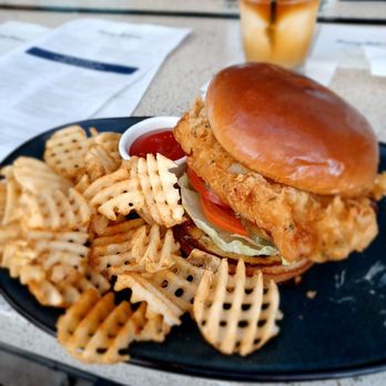 Tommy Bahama - Fish Sandwich with waffle fries. I took off the American cheese and gave it to my boyfriend lol. - Seafood Near Me - Plano, Texas