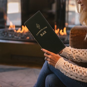 Cumberland Bar - a woman reading a book in front of a fireplace - Cocktail Bars Near Me - Nashville, Tennessee Cumberland Bar - a woman reading a book in front of a fireplace - Cocktail Bars Near Me - Nashville, Tennessee