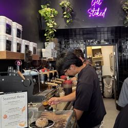 Captain + Stoker - Barista making coffee with a seasonal menu