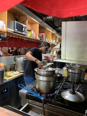 Photo of Tabata Ramen - New York, NY, US. Peeking at the action in the kitchen/bar area.