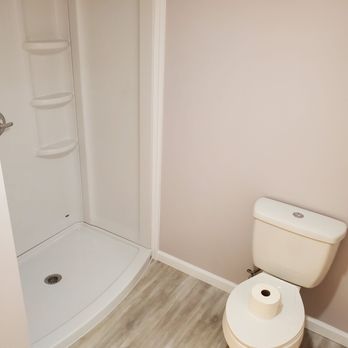 Easily Done Construction - a bathroom with a toilet and shower - Siding Near Me - New York, New York Easily Done Construction - a bathroom with a toilet and shower - Siding Near Me - New York, New York