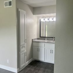 The Magnolia on 4th Apartments & Townhomes - Master Bath Vanity & Mirror In our beautiful three bedroom / 2 bath apartments