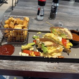 Veggie breakfast sandwich w avocado, veggies, egg, feta, home fries and salsa Veggie breakfast sandwich w avocado, veggies, egg, feta, home fries and salsa