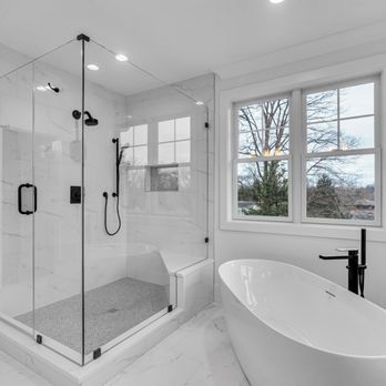 W Kitchen & Bath - Natural light highlights the seamless glass shower and elegant freestanding tub. - Kitchen & Bath Near Me - Rockville, Maryland W Kitchen & Bath - Natural light highlights the seamless glass shower and elegant freestanding tub. - Kitchen & Bath Near Me - Rockville, Maryland