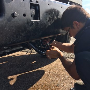 Pro Grade Mobile Mechanics & More - Sam repairing the disconnected hose on the side of the road. Notice the oil all over the ground. - Auto Repair Near Me Pro Grade Mobile Mechanics & More - Sam repairing the disconnected hose on the side of the road. Notice the oil all over the ground. - Auto Repair Near Me
