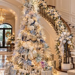 Designer Christmas tree and staircase garland in silver, ice blue, and gold, designed by Arcadia in Houston.