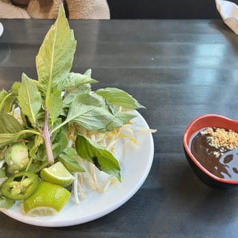 Pho Express - a plate of vegetables and a bowl of dipping sauce - Vietnamese Near Me - Colorado Springs, Colorado