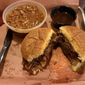 Hutchins BBQ - House Special -- close-up of the Chopped Barbecue Brisket sandwich with barbecue beans, mac & cheese, and original bbq sauce. - Barbeque Near Me - McKinney, Texas
