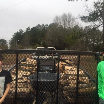 Eddie Hinson Tree Pros - two young boys standing in front of a trailer full of logs - Tree Services Near Me - Goldsboro, North Carolina Eddie Hinson Tree Pros - two young boys standing in front of a trailer full of logs - Tree Services Near Me - Goldsboro, North Carolina