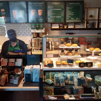 Starbucks - a woman standing in front of a counter - Coffee & Tea Near Me - Palmdale, California Starbucks - a woman standing in front of a counter - Coffee & Tea Near Me - Palmdale, California
