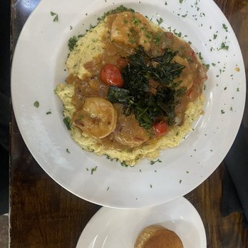Paschal's Restaurant & Bar - Shrimp and grits with those charred collards on top. - Southern Near Me - Atlanta, Georgia