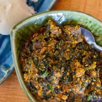 Golden Safari - Egusi - African Melon Seed & Vegetable Soup w/ Goat Meat ($18.99 + $3/Goat) also comes w/ FuFu pictured in background - African Near Me - Hayward, California