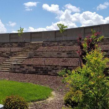 Allen Block Wall With A Blue Rock Waterfall Running Inbetween Fire