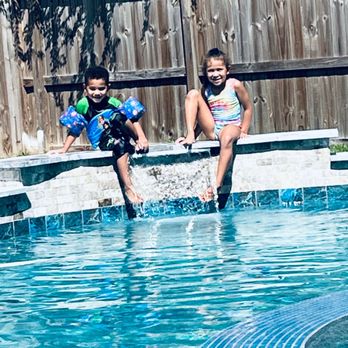 Blue Haven Pools & Spas - two children playing in the pool - General Contractors Near Me - Cypress, Texas Blue Haven Pools & Spas - two children playing in the pool - General Contractors Near Me - Cypress, Texas