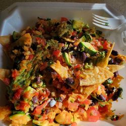 Calesa Mexican Restaurant - Custom nachos, rice shredded cheese pico de gallo guacamole black beans zucchini, with enchilada sauce salsa and sour cream on the side