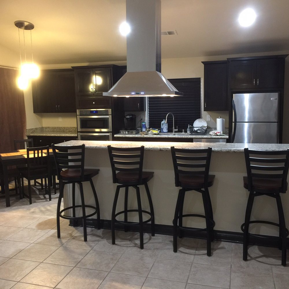 Matthews Custom Construction - a kitchen with bar stools - General Contractors Near Me