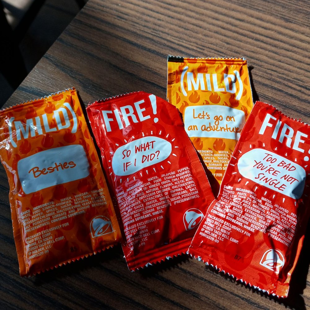 Taco Bell - three packets of chili on a table - Fast Food Near Me - Guthrie, Oklahoma Taco Bell - three packets of chili on a table - Fast Food Near Me - Guthrie, Oklahoma