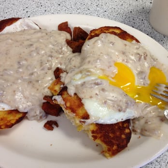 Bertha's Diner - Grilled baking powder biscuit topped with a sunny side up egg and sausage gravy w home fries on the side. $11.95! - Diners Near Me - Buffalo, New York