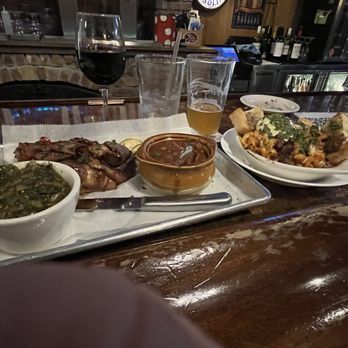 The Stein & Vine - Brisket , collard greens and baked beans on the left and baked sausage on the right. - Bars Near Me - Brandon, Florida