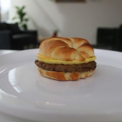The Daily Grindz - Sausage egg and cheese croissant sandwhich