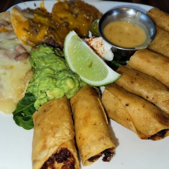 Mi Cocina - MiCocina platter appetizer.  Substituted quesadillas for more chicken flautitas. - Tex-Mex Near Me - Frisco, Texas