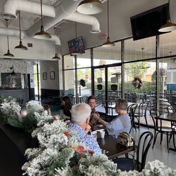 The Pizza Press - Celebration - people sitting at tables in a restaurant - Pizza Near Me - Kissimmee, Florida The Pizza Press - Celebration - people sitting at tables in a restaurant - Pizza Near Me - Kissimmee, Florida