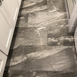 AGP Kitchen & Bath Design - Sharp grey porcelain tiles on the fbathroom floor.