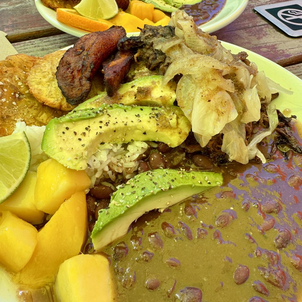 Cubo - Vaca Fritta Bowl (under a yellow  umbrella, color may be off) - Cuban Near Me - Portland, Oregon