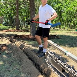 Clever Irrigation - Assistant clearing out a trench.
