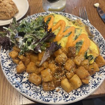 Tupelo Honey Southern Kitchen & Bar - Garden Omelet - rosemary parmesan breakfast potatoes & biscuit in back -- super yummy - New American Near Me - Greenville, South Carolina Tupelo Honey Southern Kitchen & Bar - Garden Omelet - rosemary parmesan breakfast potatoes & biscuit in back -- super yummy - New American Near Me - Greenville, South Carolina