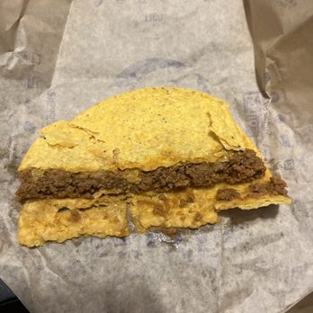 Taco Bell - This taco is rotten. Stuck to the paper and is falling apart. Smells like a can of cat food do not go to Taco Bell - Fast Food Near Me - Effingham, Illinois