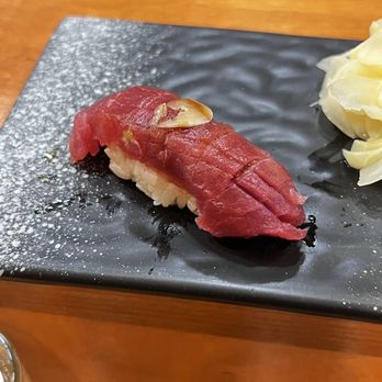 Neta Shari - Lean blue fine tuna with fresh garlic on top - Sushi Bars Near Me - Brooklyn, New York Neta Shari - Lean blue fine tuna with fresh garlic on top - Sushi Bars Near Me - Brooklyn, New York